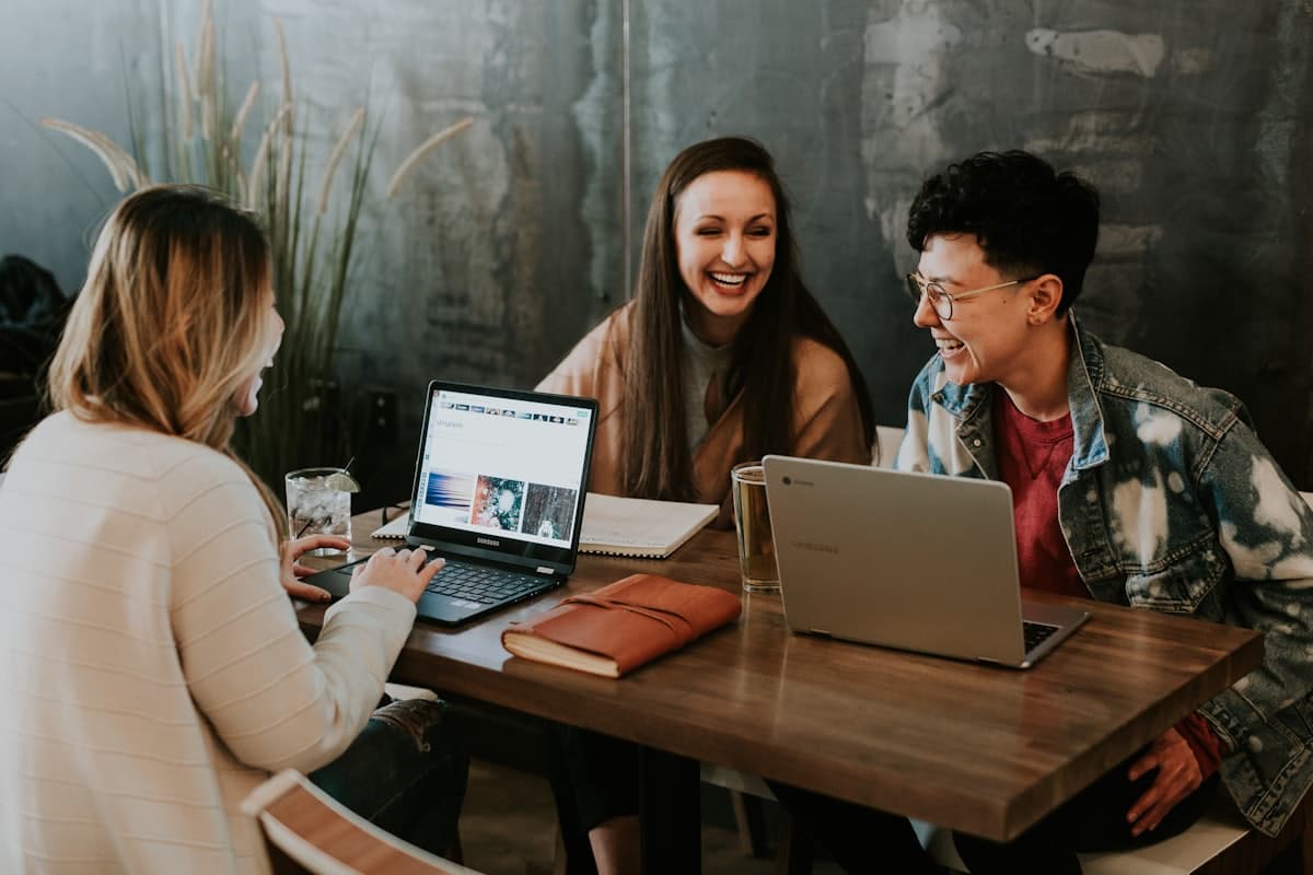A small business team collaborating around a table with laptops