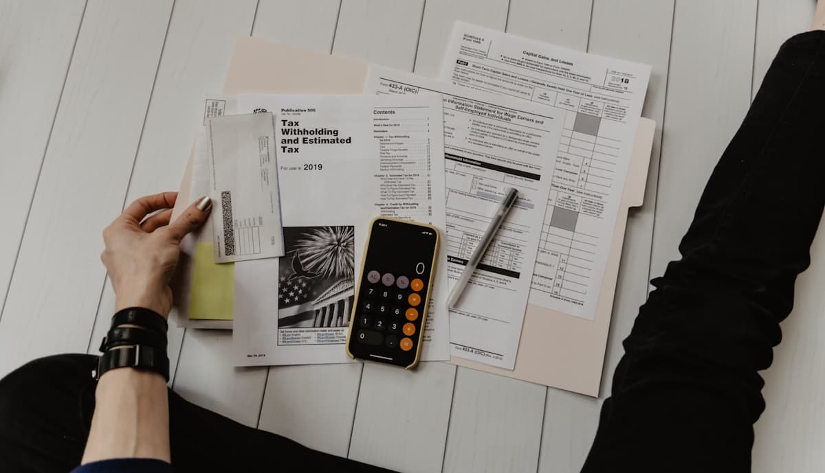 Payroll paperwork and a calculator on a desk